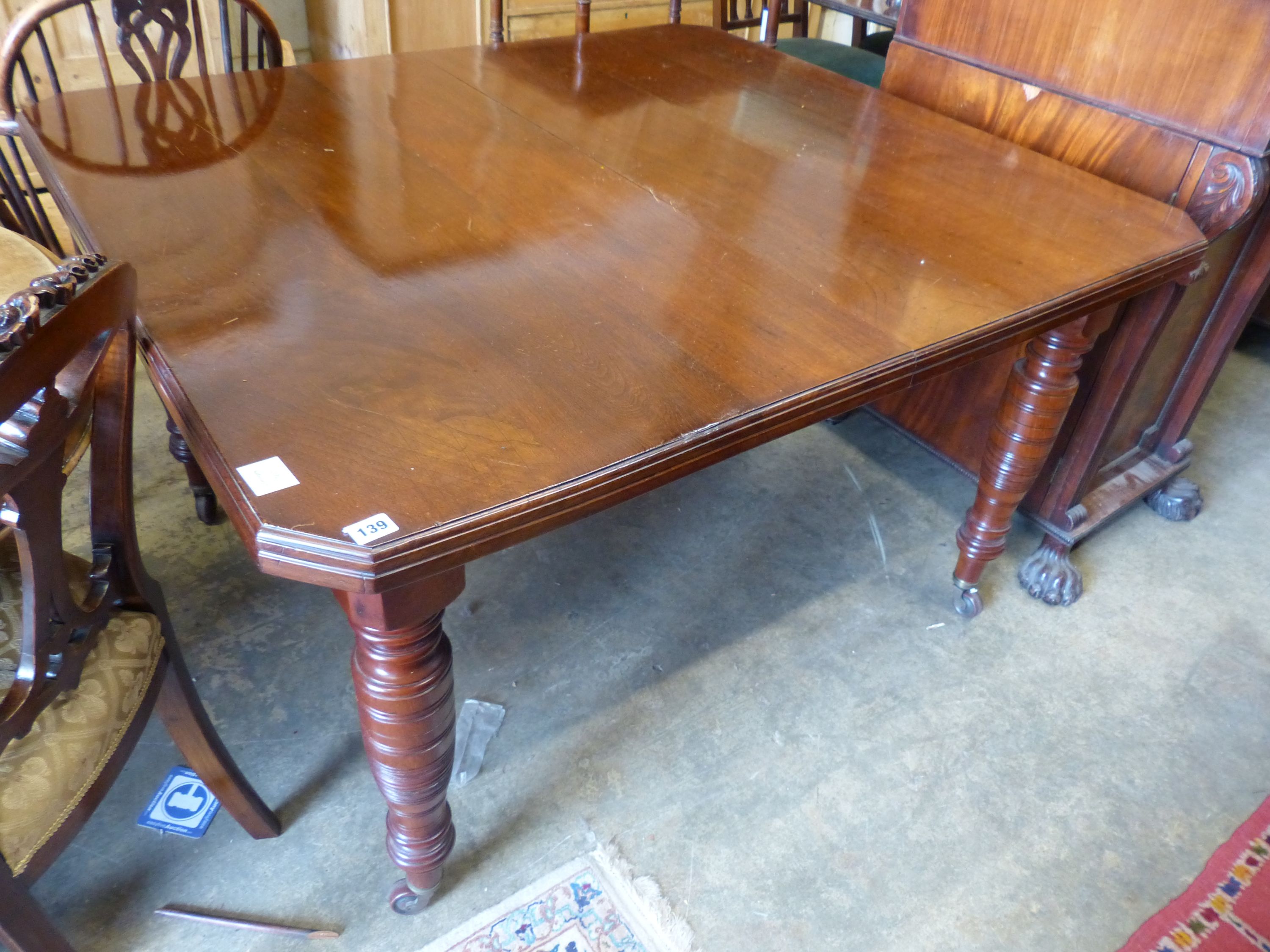 A late Victorian walnut extending dining table, (two spare leaves) 174cm extended, width 114cm, height 73cm.